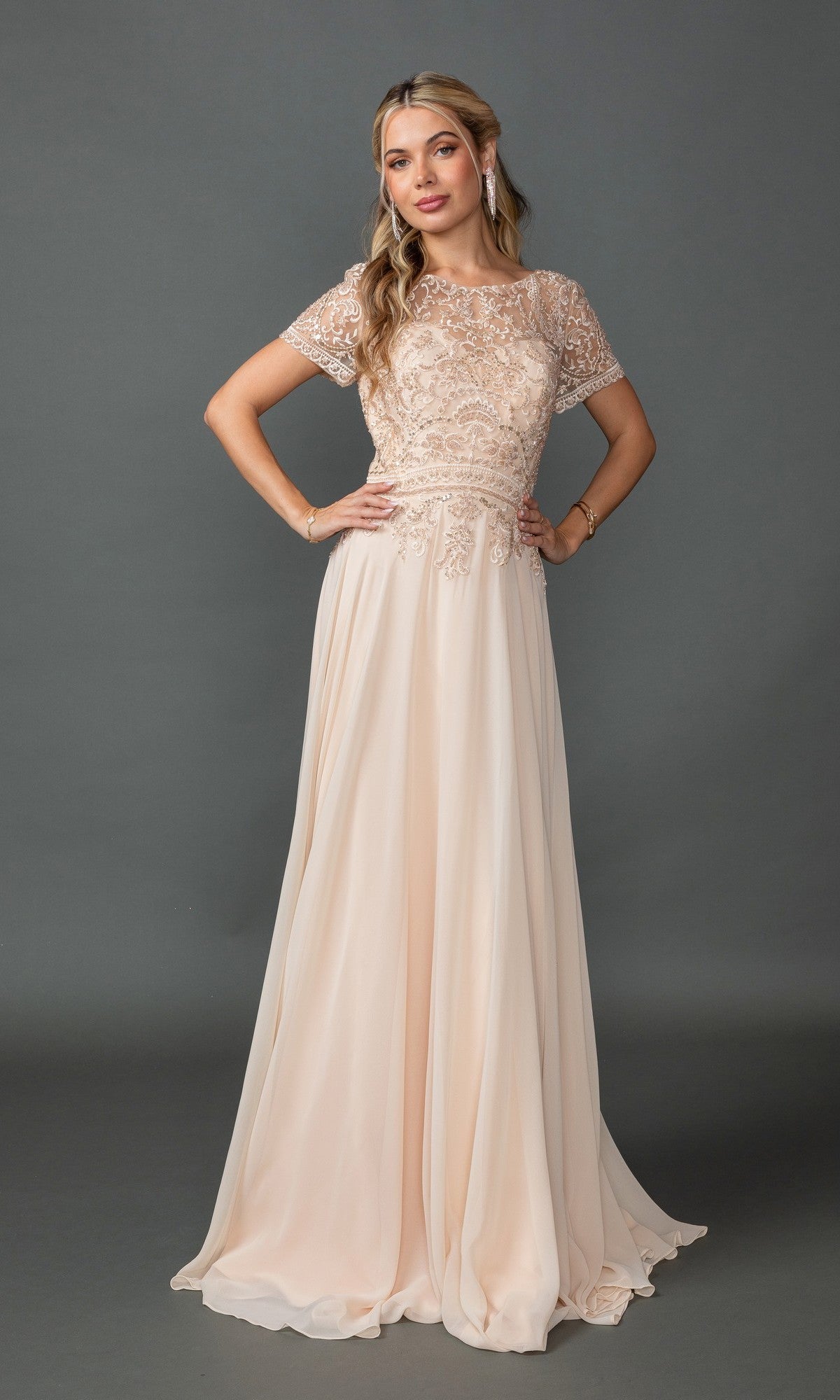 A woman models the Beaded-Bodice Long Prom Dress: Dancing Queen 4444 in champagne, featuring a floor-length skirt and short sleeves with a beaded-lace bodice, posed against a plain gray background.